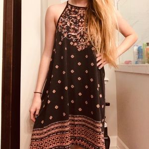 A black Roxy dress with a pink pattern design